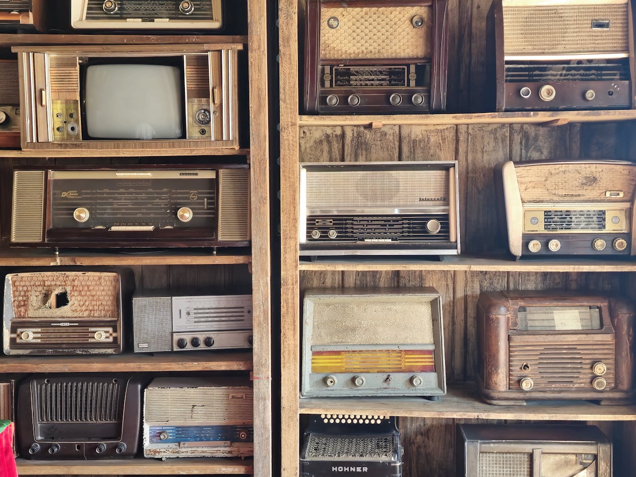 A nostalgic display of vintage radios and retro TV on wooden shelves, capturing timeless charm in Dubai.