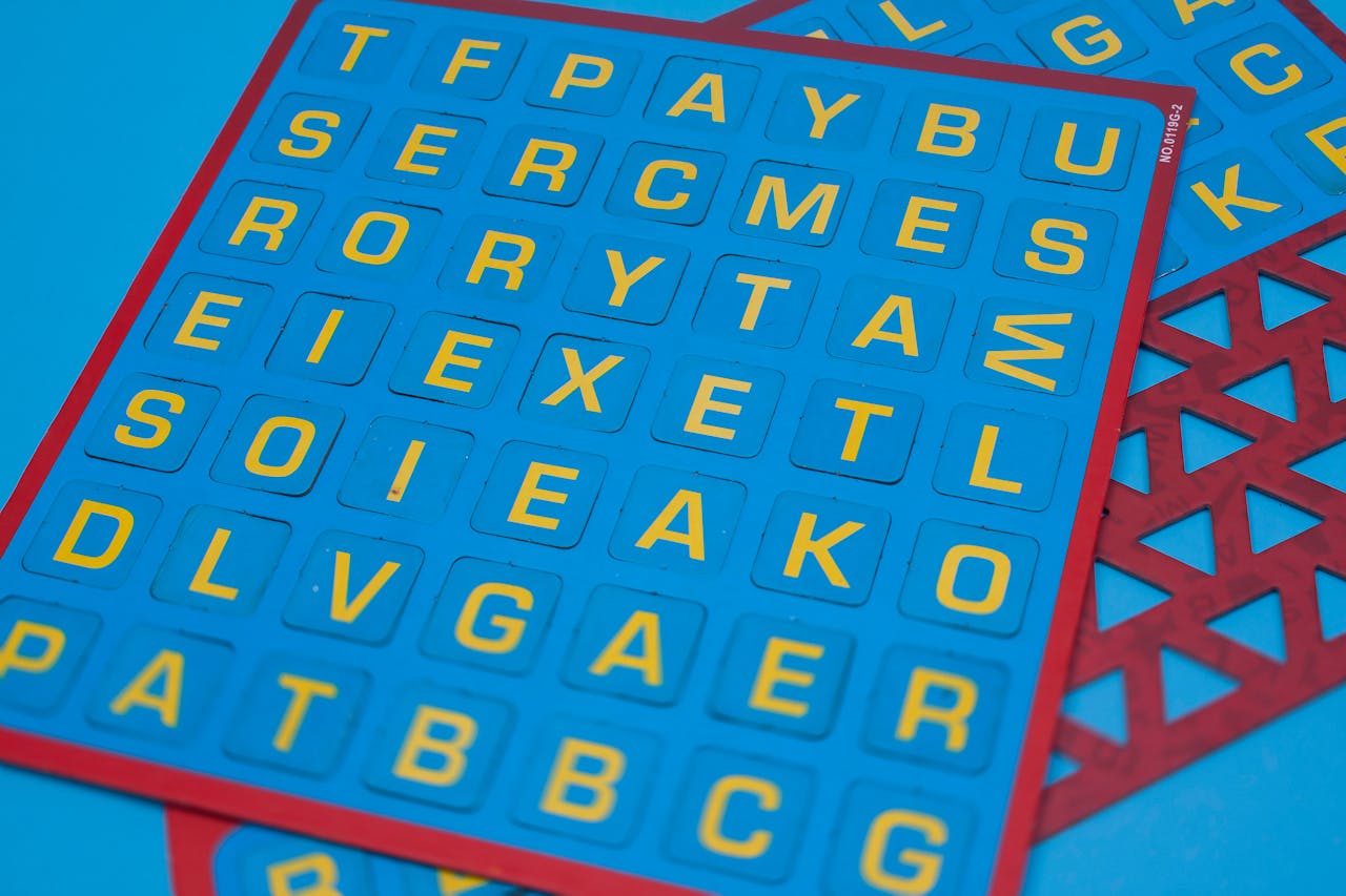 Vibrant blue puzzle board with yellow alphabet tiles arranged creatively, ideal for educational purposes.